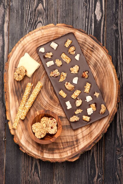 Handmade chocolate with cookies, sesame seeds and nuts