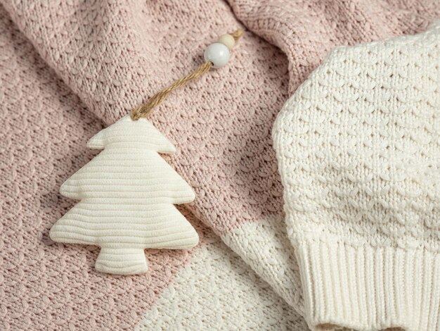 Handmade Christmas toy textile Christmas tree on the background of a knitted plaid or sweater.