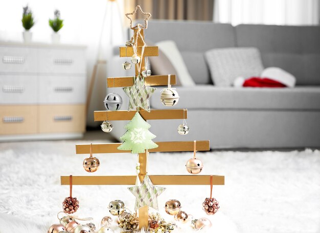 A handmade Christmas tree and baubles on the floor in the room