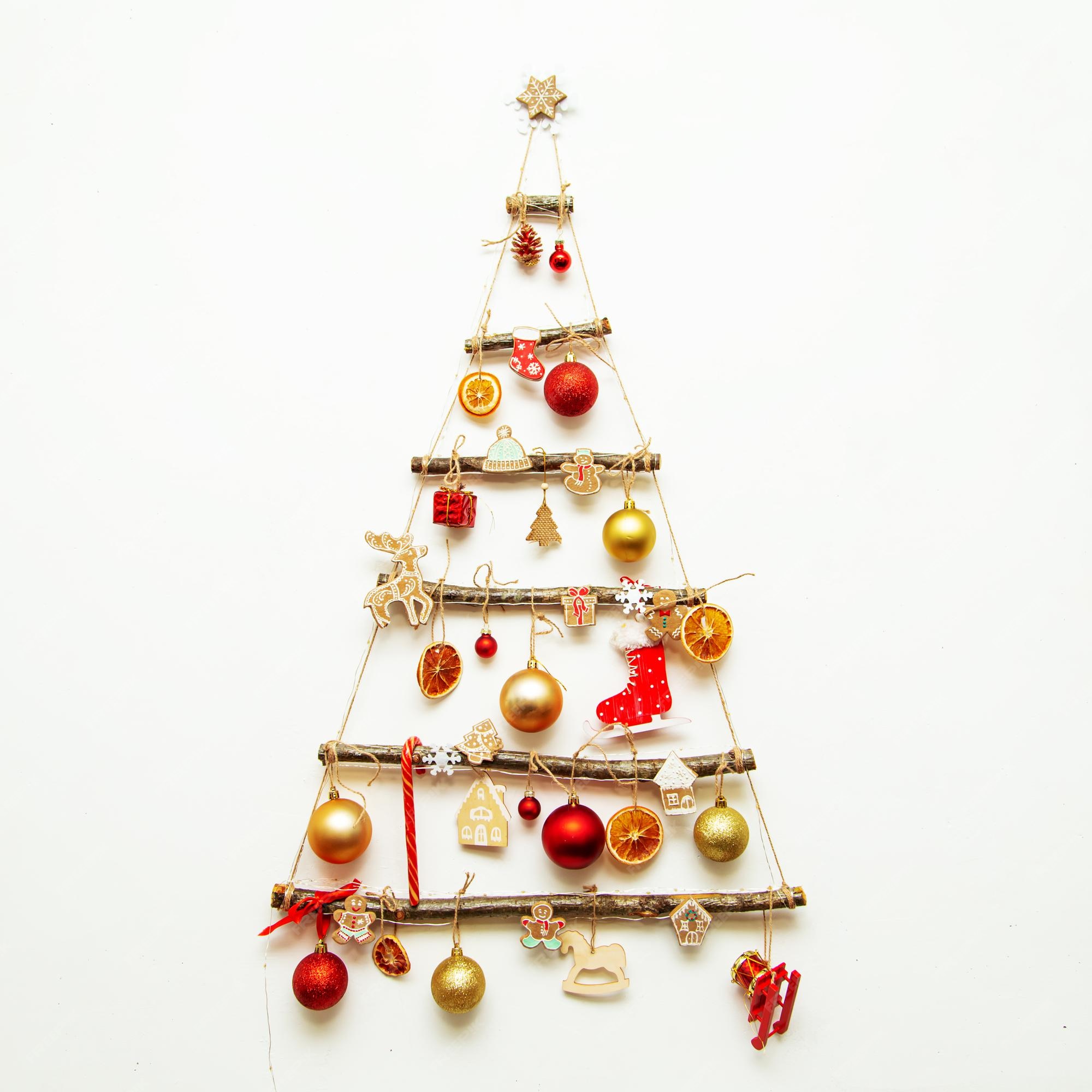 Premium Photo | Handmade christmas tree hangs on a white wall ...