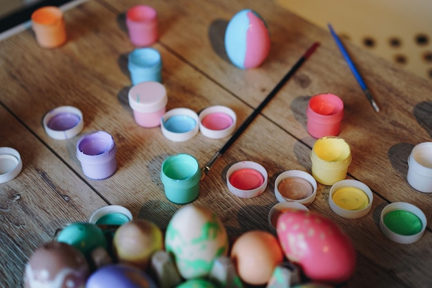 Handmade coloured eggs and acrylic paint easter flatlay