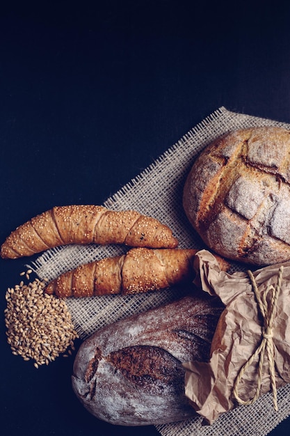 Handmade croissant and two loaves of dark bread.