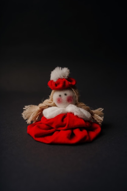 handmade cute red toy doll on black background