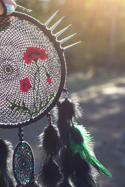 Photo handmade dream catcher with feathers threads and beads rope hanging