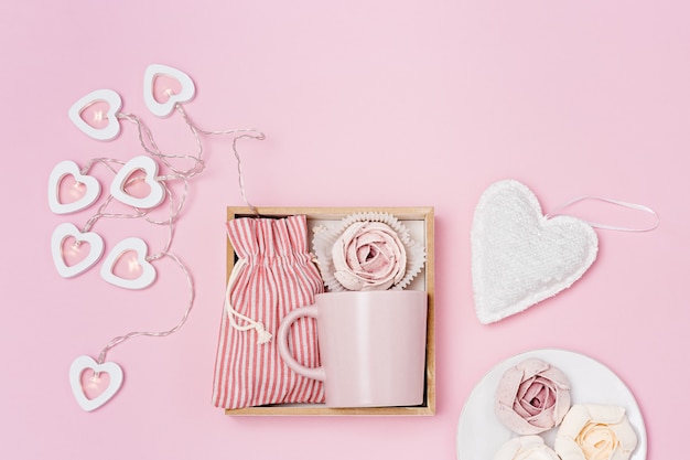 Handmade gift box with pink cup, marshmallow and surprise in textile bag, romantic present