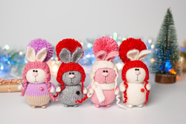 Photo handmade knitted bunny on a new year's blurred background