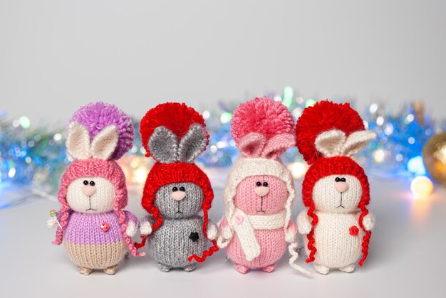 Photo handmade knitted bunny on a new year's blurred background