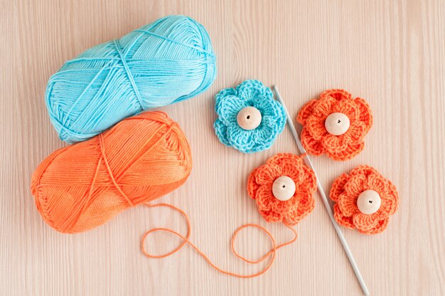 Handmade knitted crochet flowers and wood beads. Top view