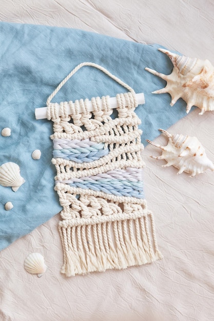 Handmade macrame 100 cotton wall hanging decoration Maritime theme Macrame braiding and cotton threads Female hobby ECO friendly modern knitting DIY natural decoration concept in the interior