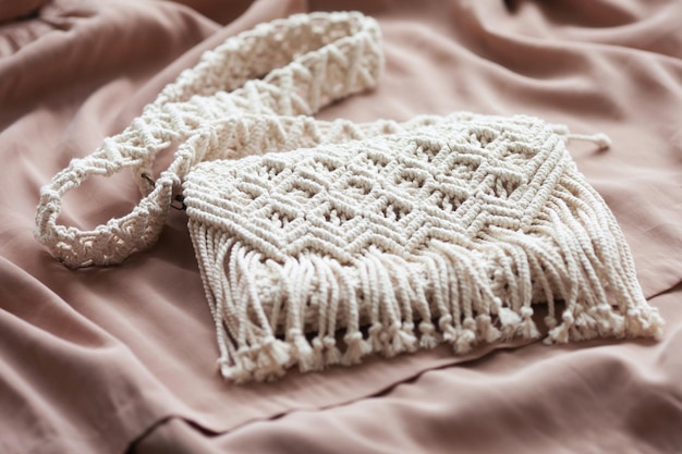 Handmade macrame cotton srossbody bag eco bag for women from\
cotton rope scandinavian style bag creme tones sustainable fashion\
accessories close up image