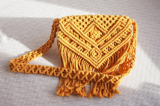 Handmade macrame cotton srossbody bag eco bag for women from\
cotton rope scandinavian style bag yellow color sustainable fashion\
accessories details close up image