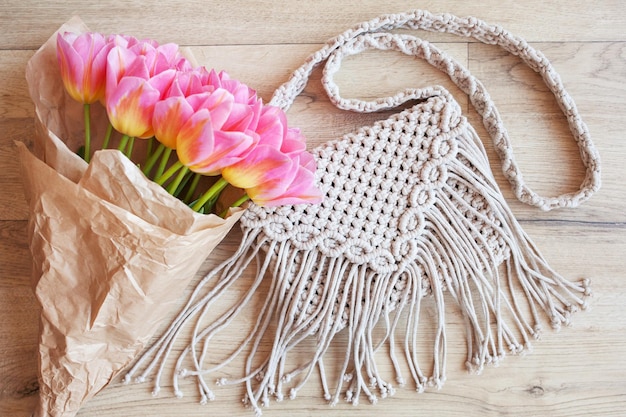 Handmade macrame cotton srossbody bag eco bag for women from
cotton rope with bouquet of flowers in kraft paper scandinavian
style bag beige tones sustainable fashion accessories