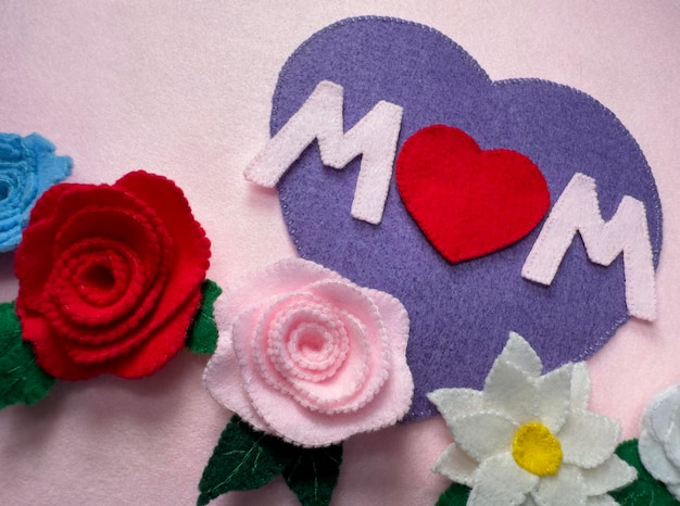 Handmade Mothers Day card with felt a purple heart with the word MOM and flowers and roses