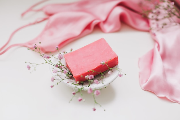 Photo handmade natural soap with ceramic dish, pink silver dress.