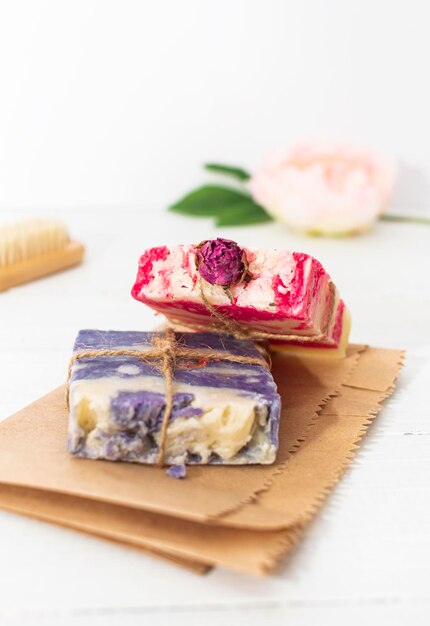 Photo handmade natural soap with rose and lavender on white wooden background