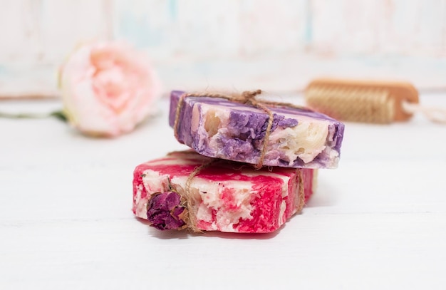 Photo handmade natural soap with rose and lavender on white wooden background