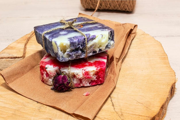 Handmade natural soap with rose and lavender on wooden paper background