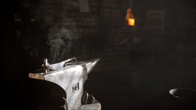 Handmade new knife with unique handle on the anvil  cool steam coming from the knife