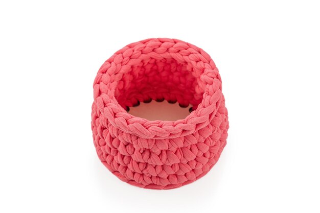 Handmade pink decorative knitted container isolated on white background