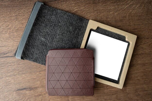 Handmade red brown wallet made of genuine leather on a wooden background Closeup top view