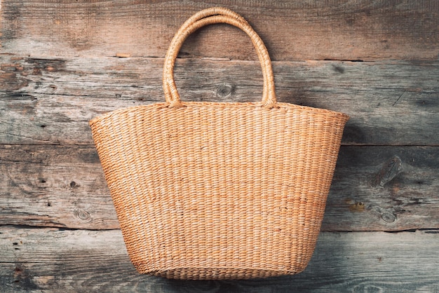 Photo handmade summer bag on wooden background top view fashionable stylish accessory natural organic eco friendly zero waste plastic free concept