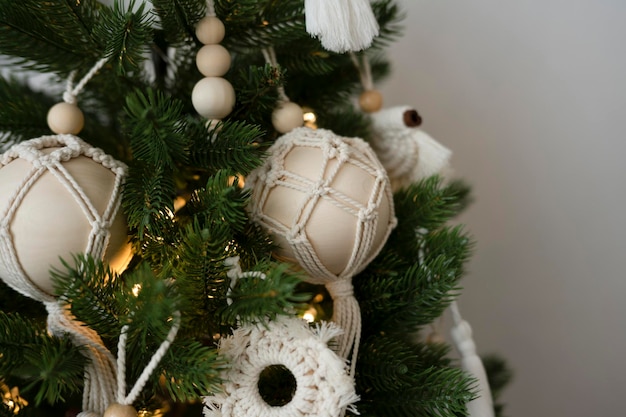 Photo handmade toys hang on an artificial christmas tree