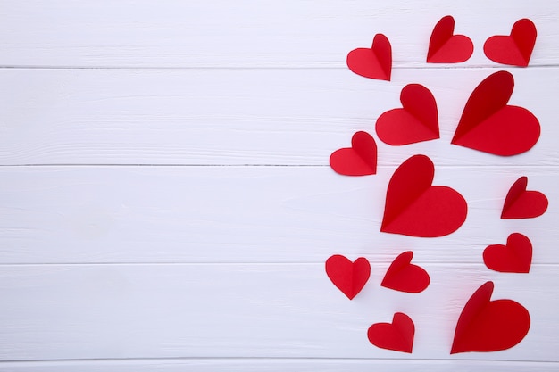 Handmaded red hearts on white background.