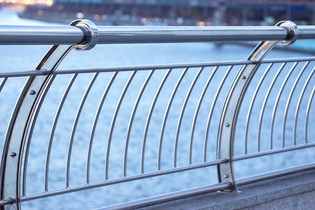 Handrail railing made of stainless material closeup near the river embankment industrial city infrastructure