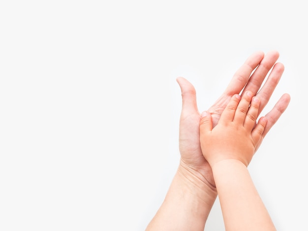 Hands of adult and child. Mother and kid put their palms together.