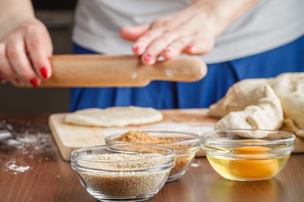 Photo hands are holding the dough