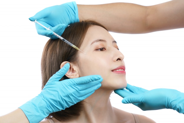 Hands of beautician injecting Botulinum toxin type A