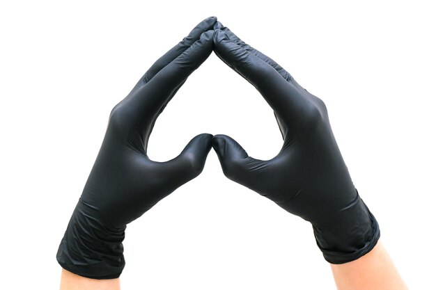 Photo hands in black gloves in the shape of a heart on a white isolated background. the concept of cosmetology, depilation, health care