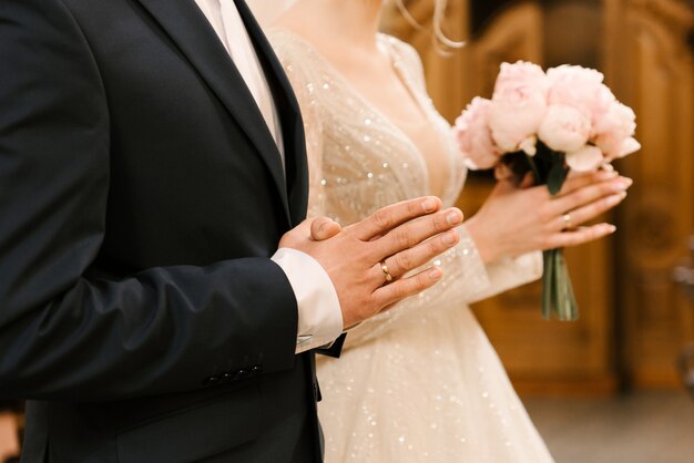 Hands of the bride and groom