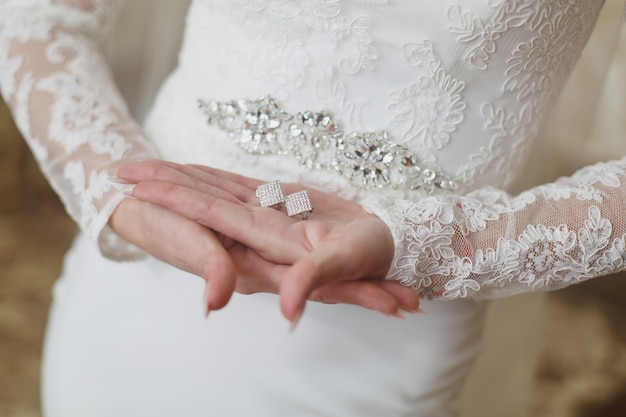 hands of the bride with delicate  jewelry. 