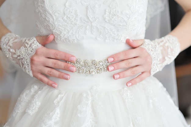 Hands bride with a manicure on the finger of the bride wedding