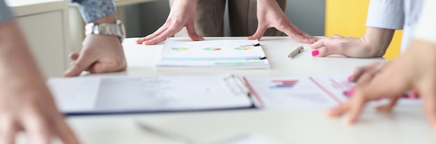 Hands of business people at work table with commercial charts. business analytics and company development strategy concept