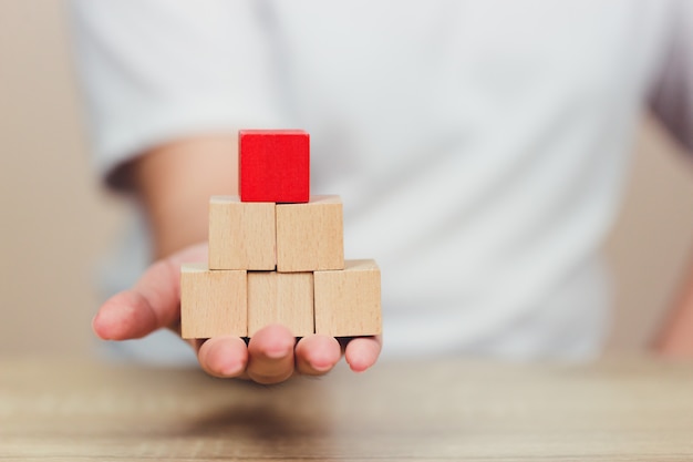 Hands of business,stacking wooden blocks.