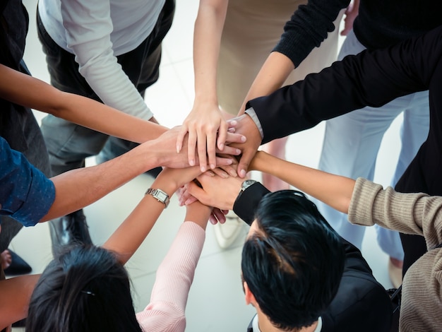 Hands of business team on workspace background top view,business team concept