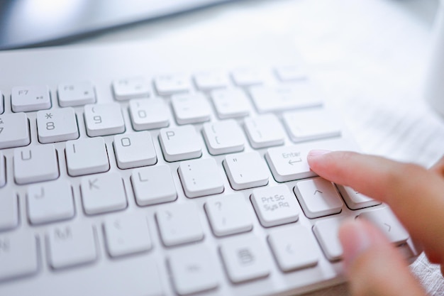 Hands of business woman Pressing enter button on computer keyboard