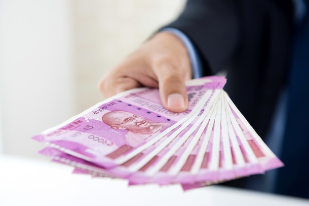 Photo hands of businessman holding money, indian rupee currency