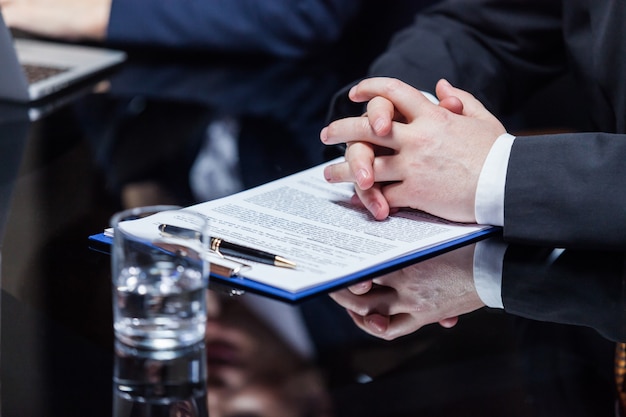 Hands of businessman on papers