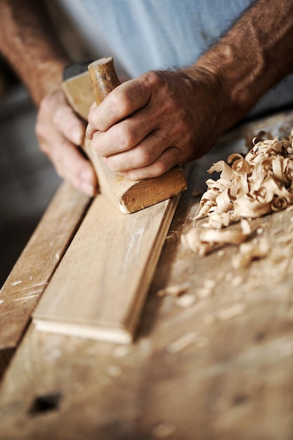 Hands of a carpenter close up