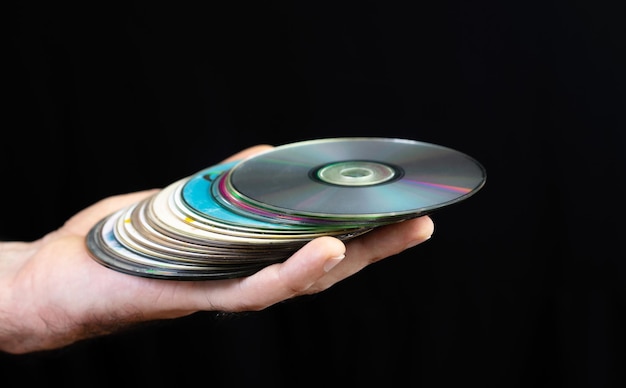 Hands and CD discs on a black background