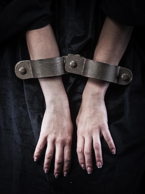 Photo hands in chains woman prisoner concept