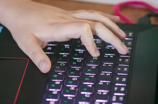 Hands of child using laptop