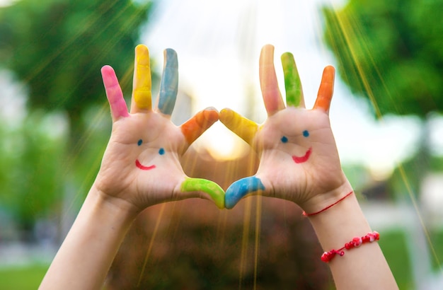 Photo hands of a child with a drawn smile selective focus