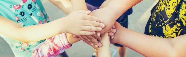 Hands of children, many friends, games. Selective focus