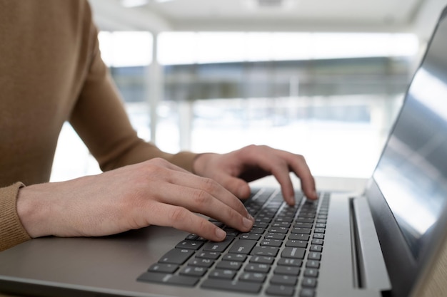 Hands of contemporary ceo or entrepreneur typing on laptop keyboard