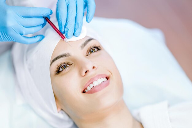 The hands of a cosmetologist performing injections Rejuvenation hydration lift Cosmetology clinic