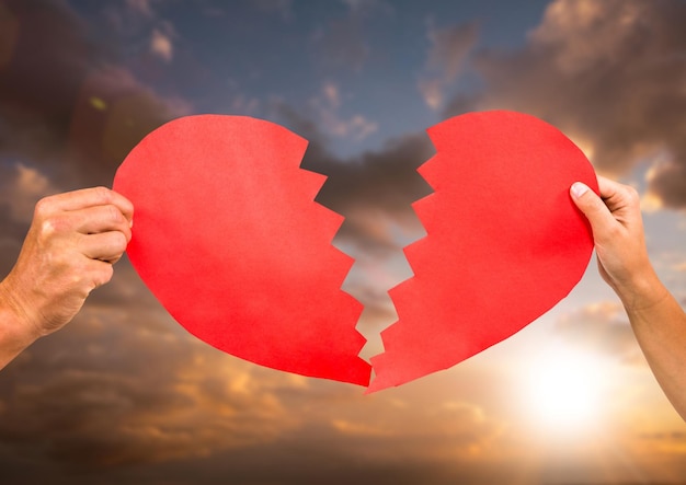 Hands of couple holding broken heart